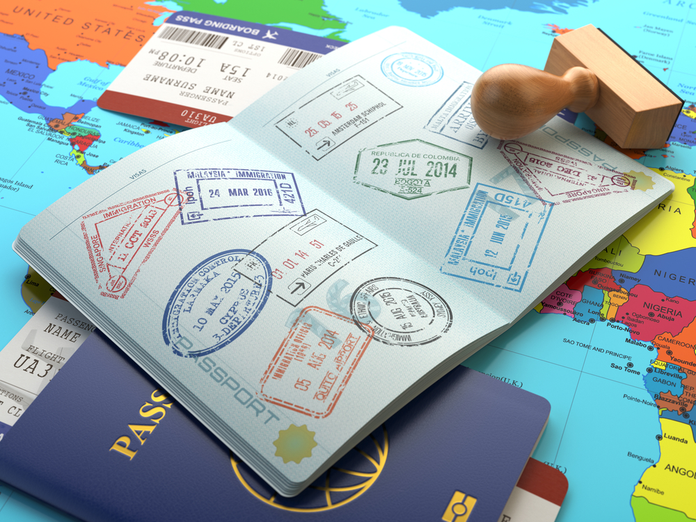 Travel,Or,Turism,Concept.,Opened,Passport,With,Visa,Stamps,With